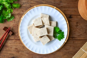 Vietnamese Pork Sausage  on a white plate ,cube Vietnamese Pork sausauge on wooden background, top view food table