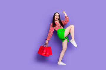 Full length photo of lovely young lady shopping bags winning dressed stylish pink garment isolated...
