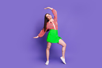 Full length photo of lovely young lady dancing have fun dressed stylish pink garment isolated on violet color background