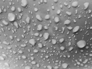 Selective focus water droplets on white car with small dust stains