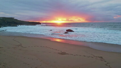 Sunrise glowing marine horizon over foaming ocean waves. Sunset illuminating sea