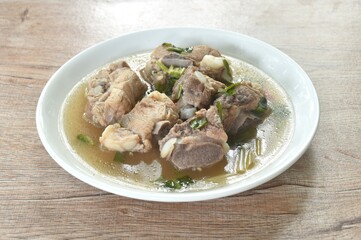hot and spicy pork bone with tamarind and Thai herbs soup on plate