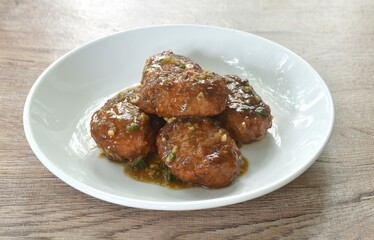 fried salt crispy chop chicken meat dreading garlic and pepper gravy sauce on plate 