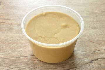 palm sugar in circle transparent plastic box packaging on table