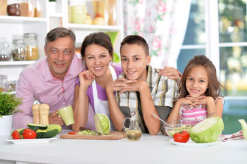 Portrait of beautiful family cooking at kitchen