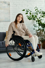 A young woman in a wheelchair sits in her living room.