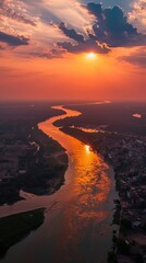 Aerial view of the beautiful sunset over the Ganges river passing through populated areas