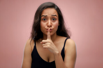 Young Beautiful Woman With Long Hair Putting Her Fingers On Her Mouth