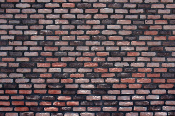 Brick wall background. Red, brown, black old bricks masonry backdrop. Stone texture for architecture and interior.