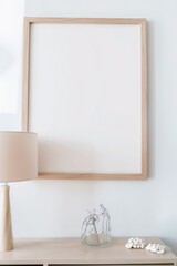 Cozy Living Space: Blank Light Wooden Frame Mockup on Plain Background with Clean Living Room Setting and Good Lighting