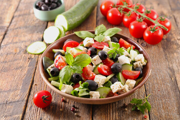 greek salad with lettuce, tomato, feta cheese and black olive