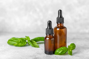 Basil essential oil on a textured wooden background. Basil essential oil and fresh leaves. Aromatherapy. Aroma oil. Medical herbs. Alternative medicine. Place for text. Copy space.