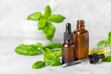 Basil essential oil on a textured wooden background. Basil essential oil and fresh leaves. Aromatherapy. Aroma oil. Medical herbs. Alternative medicine. Place for text. Copy space.