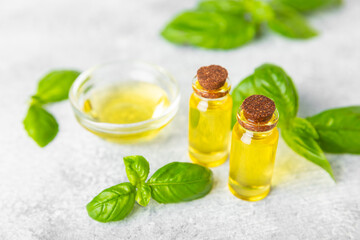Basil essential oil on a textured wooden background. Basil essential oil and fresh leaves. Aromatherapy. Aroma oil. Medical herbs. Alternative medicine. Place for text. Copy space.