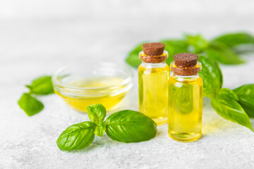 Basil essential oil on a textured wooden background. Basil essential oil and fresh leaves. Aromatherapy. Aroma oil. Medical herbs. Alternative medicine. Place for text. Copy space.