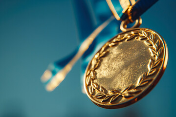 Close-up of a gold medal with blue ribbon on a blurred background. Concept of victory, achievement, and excellence in sports or academics. Award and recognition background.