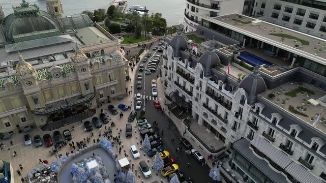 Aerial drone shot captures Monaco's Hotel de Paris Monte-Carlo, featuring the picturesque coastline.
