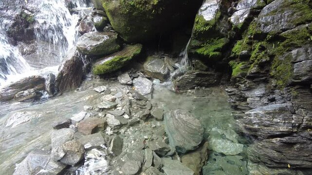 Stream of Franz Josef Glacier flowing on rocks in Westland Tai Poutini National Park, New Zealand