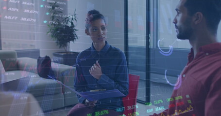 Image of graphs and trading boards over diverse coworkers discussing in office