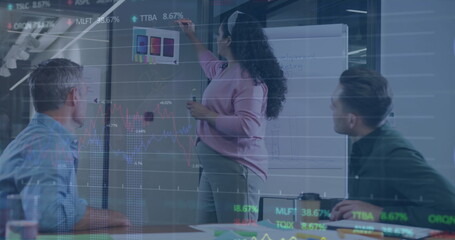 Image of graphs and trading boards over diverse coworkers planning strategy in office