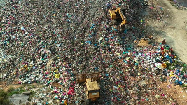 A massive landfill site with unsorted wastes, highlighting critical issues of environmental sustainability, microplastic pollution and devastating impacts of global warming and climate change.