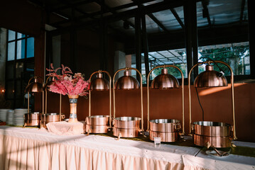 Empty food containers with plates and spoons, prepared in anticipation of freshly cooked meals