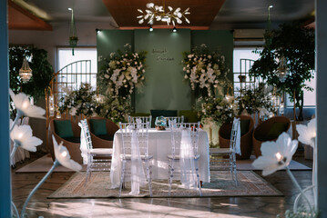 Bogor, June 21 2024. Elegant wedding table decor, featuring white flowers and candles, perfect for a solemn ceremony