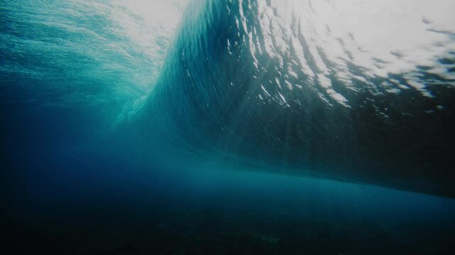 Dark mystic water rises into stunning clear barrel with mist and foam at Cloudbreak Fiji