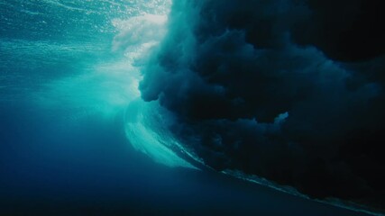 Underwater view of ocean wave crashing and turning in vortex at Cloudbreak Fiji