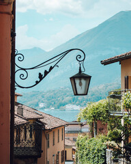 Captivating photograph of an iconic street in Bellagio, Italy, with a streetlight in the foreground...