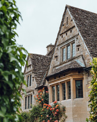 Charming photo of a traditional Cotswold building in England, showcasing its iconic honey-colored limestone exterior under soft, natural light.
