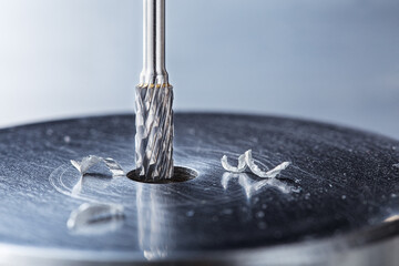 Milling cutter make sink in hole in steel billet. Locksmith work.