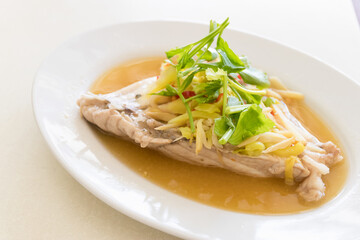 Delicious and healthy steamed fish with ginger and scallions, served with jasmine rice.