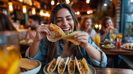 Happy woman enjoying tacos with friends in a vibrant Mexican restaurant, sharing a joyful meal and laughter during lunch.