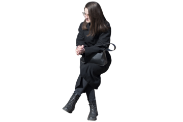 A woman in black coat in sitting pose isolated	