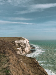 Moody photograph of the iconic White Cliffs of Dover, captured under a dramatic sky. 