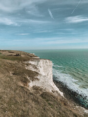 Moody photograph of the iconic White Cliffs of Dover, captured under a dramatic sky. 