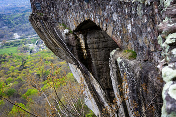 solid rock cliff face with cobble stone bridge high on Lookout Mountain in Chattanooga Tennessee with view of city below.