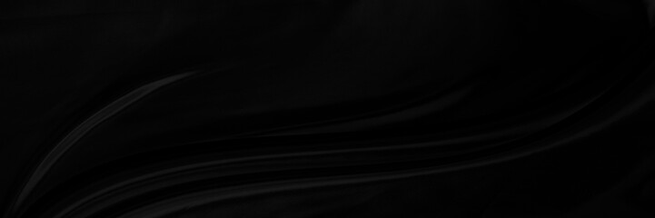 Black gray satin dark fabric texture luxurious shiny that is abstract silk cloth panorama background with patterns soft waves blur beautiful.
