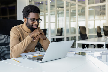 African american young man working in the office and looking busy