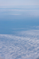 A beautiful landscape of clouds seen through an airplane window