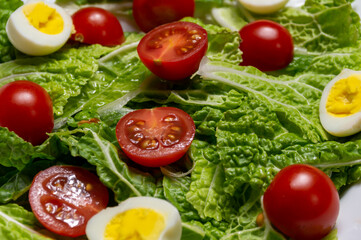 Tasty salad with lettuce, tomatoes, and hard boiled eggs