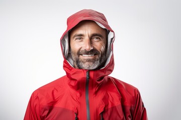 Fototapeta premium Portrait of a content man in his 40s wearing a windproof softshell on white background