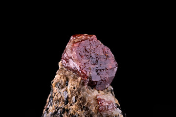 Red Zircon crystal photography. Specimen From Haramosh Mountains, Gilgit-Baltistan, Pakistan. isolated on black background. macro detail close-up rough raw unpolished