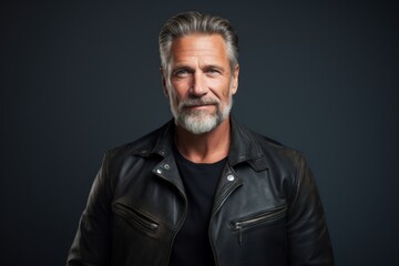 Fototapeta premium Portrait of a happy man in his 50s sporting a classic leather jacket in front of modern minimalist interior
