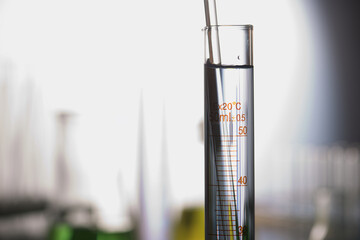 Laboratory glassware placed in a  table with liquid sample