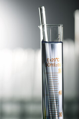 Laboratory glassware placed in a  table with liquid sample