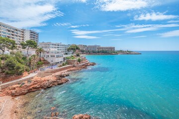 View of part of the promenade that connects the beaches of the city of Salou with the arrival of tourists Sea and palm trees in the tourist town of Costa Dorada