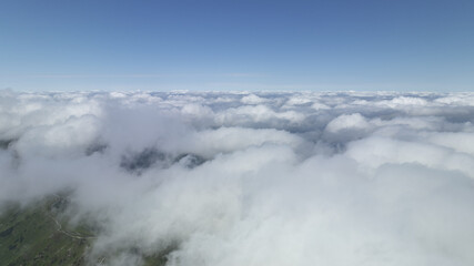 Plane in foreground, clouds below