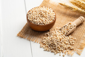Uncooked barley, Heap of pearl barley on wooden table with copy space